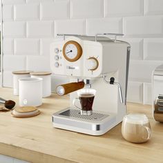 an espresso machine sitting on top of a wooden counter