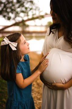 a pregnant woman holding her child's belly