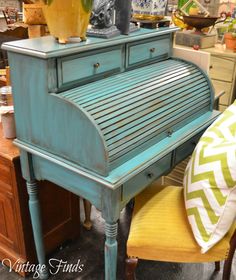 a blue piano sitting on top of a wooden table