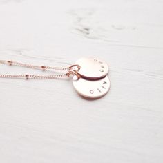 "I am in love with the color of rose gold! I'm excited to offer my best selling necklace in this warm, luxurious metal! The names of your choosing are hand stamped on rose gold filled medallions and lay on a delicate beaded rose gold filled chain. . { d e t a i l s } . Made to order. rose gold filled. . { m e a s u r e m e n t s } . 1/2\" disc 16 or 18\" in length . { o p t i o n s } . Please leave personalization preference in the notes to camileedesigns field at checkout This design in traditi Adjustable Rose Gold Charm Necklace With Custom Name, Rose Gold Hand Stamped Sterling Silver Necklace, Hand Stamped Sterling Silver Necklace In Rose Gold, Rose Gold Sterling Silver Hand Stamped Necklace, Rose Gold Sterling Silver Necklace With Hand Stamped Details, Hypoallergenic Rose Gold Sterling Silver Charm Necklace, Personalized Dainty Rose Gold Charm Necklaces, Personalized Dainty Rose Gold Charm Necklace, Minimalist Rose Gold Hand Stamped Charm Necklaces