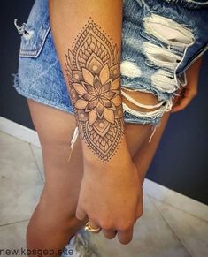 a woman's arm with a tattoo on it and a flower in the middle