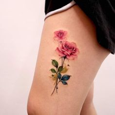 a woman's thigh with pink roses on it