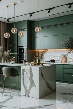 a kitchen with marble counter tops and green cabinets, along with two bar stools