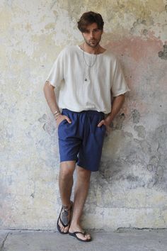 Introducing our Boreas Men's Linen Cotton Shortsin indigo blue, the perfect addition to your summer wardrobe. These shorts are expertly handmade in Istanbul, ensuring their superior quality. We have used a high-quality blend of linen, cotton, and viscose materials to create a lightweight, breathable, and durable pair of shorts. The fabric composition of our shorts ensures they are comfortable to wear all day long. Featuring a minimalist design, our Boreas shorts are both stylish and comfortable. The elastic waistband and drawstring allow for a perfect fit, adapting to your body shape. The two side pockets provide added functionality, allowing you to carry your essentials conveniently.  In a vibrant dark indigo color, our Boreas shorts offer a versatile and timeless style that can easily be Cotton Pants With Built-in Shorts For Vacation, Beach Pants With Built-in Shorts, Blue Bermuda Shorts For Summer Vacation, Blue Summer Bermuda Shorts For Vacation, Relaxed Fit Blue Bermuda Shorts For Summer, Blue Bermuda Shorts For Beach With Pockets, Blue Bermuda Shorts With Pockets For Beach, Summer Navy Bottoms With Built-in Shorts, Navy Summer Bottoms With Built-in Shorts