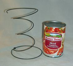 a can of canned food next to a wire sculpture