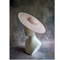 One cartwheel sinamay straw hat base in rose petal pink blush that measures approximately 15" (38cm) in diameter. Crown is 1.5" (3.8cm) high. The edges of the brim are finished in wired sinamay. The multi-layer stiffened sinamay straw has a great sturdy weave and provides excellent support for your millinery creations. Sinamay is a natural material and you will see occasional beige / brown fibers / striations in the weave. This is not a defect, but is the result of how different natural fibers respond to dye and processing. This is NOT a ready to wear finished hat and will not stay on your head unless you add a head band or elastic to wear. Add embellishments of your choice.  A nice high quality base - I know you'll be pleased! This hat base is listed separately in over a dozen different c Fitted Felt Hat With Flat Crown For Spring, Formal Flat Crown Panama Hat For Spring, Formal Panama Hat With Flat Crown For Spring, Formal Panama Hat With Flat Crown, Classic Pink Wide Brim Hat, Elegant Felt Hat With Flat Crown For Spring, Elegant Spring Sun Hat With Flat Crown, Elegant Spring Felt Hat With Flat Crown, Classic Pink Hat With Curved Brim