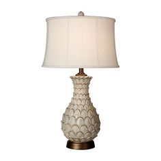 a table lamp with a white shade on it