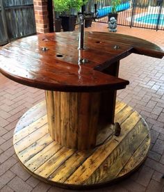 an outdoor table made out of wooden boards