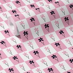 a pink and white checkered wallpaper with black flower designs on it's side