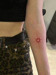 a woman with a red star tattoo on her arm