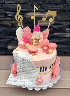 a cake decorated with musical notes and pink frosting