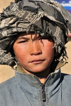 a young boy with a hat on his head