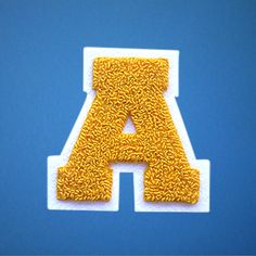 the letter a is made out of gold thread