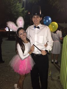 a man and woman dressed up in costumes for an easter egg hunt at the park