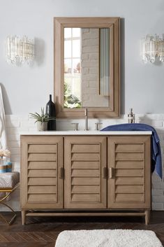 a bathroom with a sink, mirror and rug