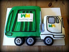 a birthday cake made to look like a truck and tractor with the letter m on it