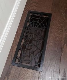 a wooden floor with a spider web on it