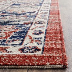 a red, white and blue rug with an ornate design on the bottom half of it