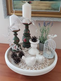 a tray with candles, pine cones and other decorations