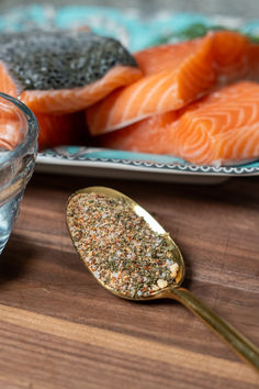 there is a spoon with some sea salt on it next to other foods and drinks