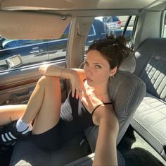 a woman sitting in the back seat of a car