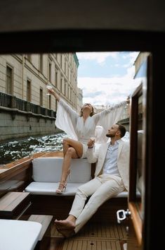 a man and woman sitting on the back of a boat