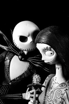 two creepy dolls are standing next to each other with their faces painted black and white