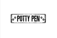 a sign that says potty pen with paw prints on the front and back of it