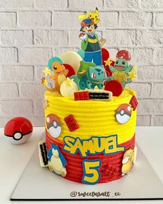 a pokemon themed birthday cake with the number 5 on it's side and various characters