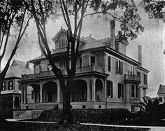 an old black and white photo of a large house with two stories on the second floor