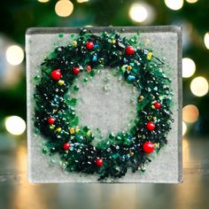 a christmas wreath made out of plastic beads