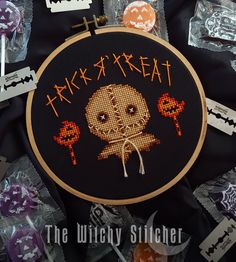 a cross - stitch pattern with the words trick treat on it, surrounded by halloween candies