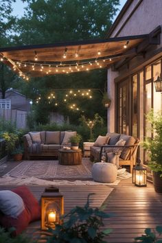 an outdoor living area with lights strung over the patio and seating on the deck, surrounded by greenery