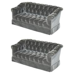 two grey velvet chesterfield style sofas, one with buttons on the back and one without