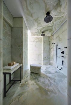 a bathroom with marble floors and walls