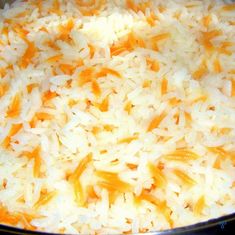 rice and carrots cooking in a pan on the stove