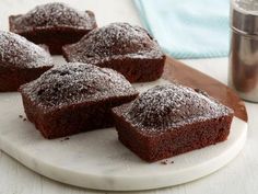 some brownies are sitting on a white plate