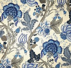 a blue and white floral wallpaper with lots of flowers on it's side