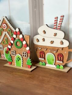 two gingerbread houses are sitting next to each other