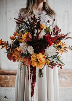 a woman holding a bouquet of flowers in her hands