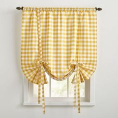 a yellow and white checkered window valance with two ties on the bottom, hanging from