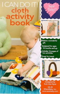 a baby sitting on the floor playing with an activity book