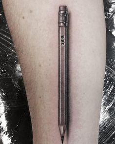 a black and white photo of a person's leg with a pen on it