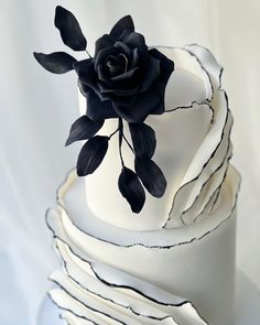 This black & white monochrome wedding cake with torn fondant side ruffles and striking Handmade Black fondant sugar rose and leaves by Roseberry Cake Creations 🍰🖤🤍🖤 #cake #weddingcake #weddingideas #blackandwhite #monochrome #cakedesigner #cakedecoratingtechniques #sugarart #weddings Black Rose Wedding Cake, Fondant Ruffle Wedding Cake, White Wedding Cake With Black Accents, Black Tie Wedding Cake Ideas, Simple Black And White Wedding Cake, Monochrome Wedding Cake, Black And White Wedding Cake Elegant, Black Draping Wedding, Black Rose Cake