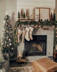 a living room decorated for christmas with stockings and garlands on the fireplace mantel