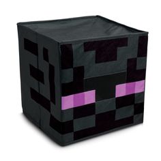 a cube made out of black and purple material with pink squares on the sides, sitting in front of a white background