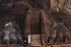 an elephant statue is in front of a staircase and rock formation at the base of a mountain