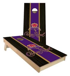 a purple and black cornhole game with the crown on it's back end