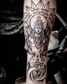 a person with a tattoo on their arm that has an image of the hindu god