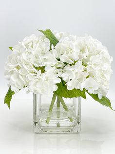 a vase filled with white flowers on top of a table